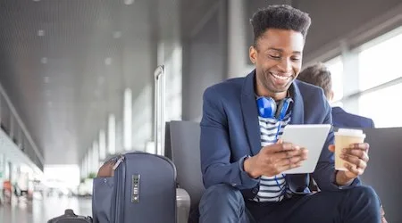 Man at the airport with a coffee.